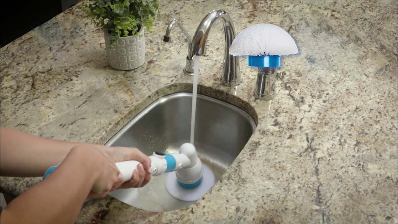 washing the kitchen sink with an electric brush